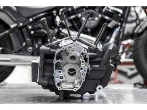 V8 engine component for Harley Davidson motorcycle, black and metallic finish.