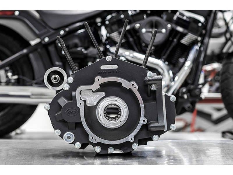 High-performance motorcycle engine part on grey surface at Revelry Motorcycles shop.
