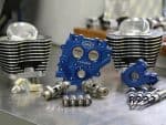 High-performance motorcycle engine parts including cylinder heads and camshafts from Revelry Motorcycles.