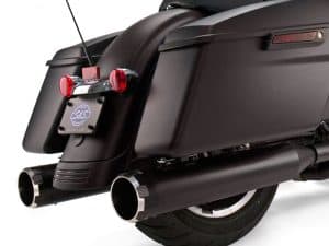 Sleek black motorcycle with dual exhaust pipes and rear luggage storage, perfect for Harley enthusiasts.