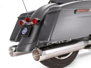 Black touring motorcycle with chrome exhaust pipes and rear luggage storage.