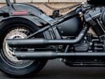 Dark matte motorcycle exhaust and engine close-up, Harley-Davidson style, ideal for motorcycle accessories and customisations.