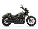 Harley Davidson black and green cruiser motorcycle with custom black exhaust pipes.