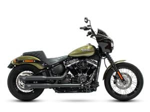 Harley Davidson black and green cruiser motorcycle with custom black exhaust pipes.