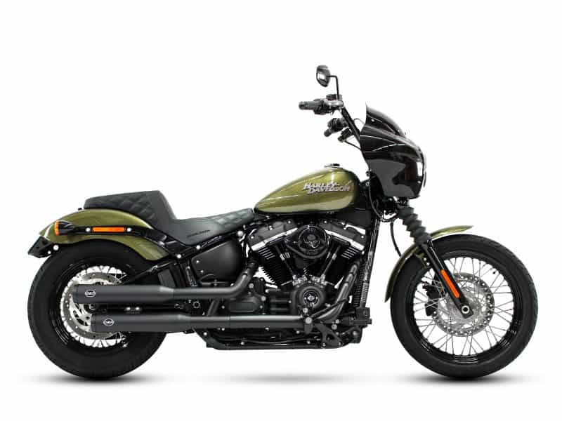 Harley Davidson black and green cruiser motorcycle with custom black exhaust pipes.