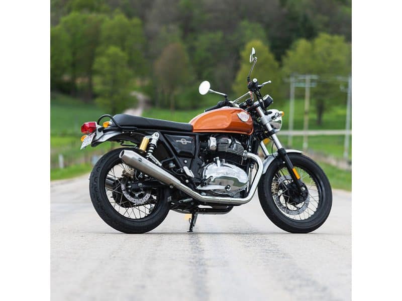 Tapered Cone Slip-On Mufflers - Stainless Steel. Fits Royal Enfield 650 Twins 2019up Motorcycle sitting on a rural road with green trees in the background, showcasing Revelry Motorcycles' vintage-inspired design and quality.