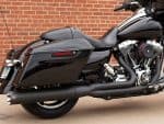 Sleek black touring motorcycle with custom exhaust, perfect for long rides and motorcycle enthusiasts.