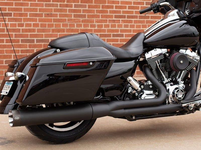 Sleek black touring motorcycle with custom exhaust, perfect for long rides and motorcycle enthusiasts.