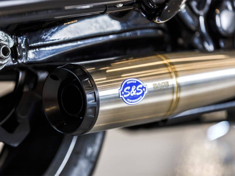Bold stainless steel motorcycle exhaust pipe with S&S Performance logo, perfect for custom Harley Davidson bikes.