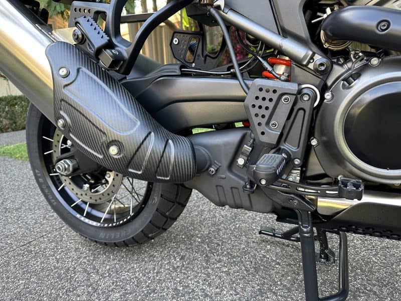 High-performance motorcycle exhaust and engine components with carbon fibre details.