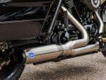 Exhaust system detail of Revelry Motorcycles Harley-Davidson motorcycle, showcasing high-performance S&S exhaust.