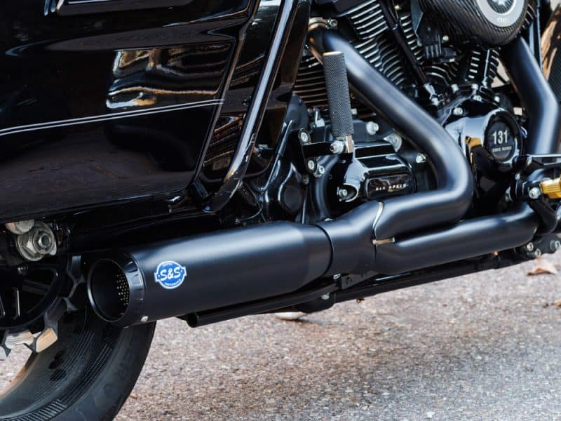 High-performance black motorcycle exhaust pipe with Revelry Motorcycles branding, designed for Australian riders.