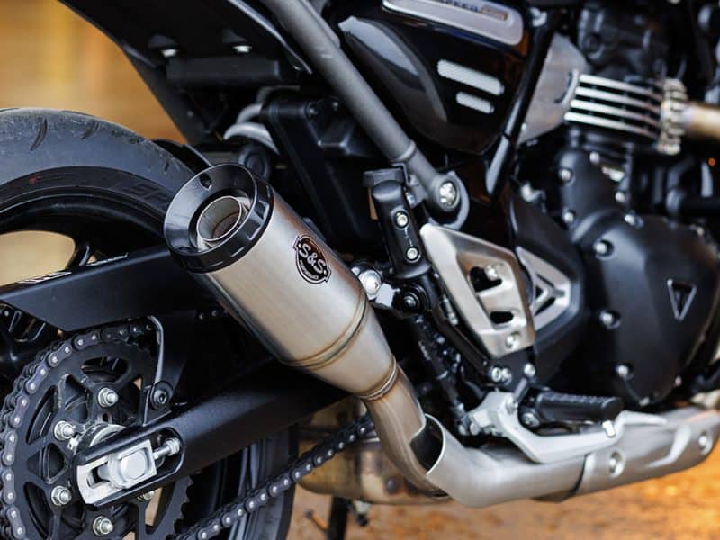 S&S exhaust system on black motorcycle, close-up shot.