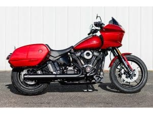 Harley Davidson motorcycle with red fairings and saddlebags, styled for cruising and touring.