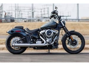 Harley Davidson motorcycle on city street in black colour.