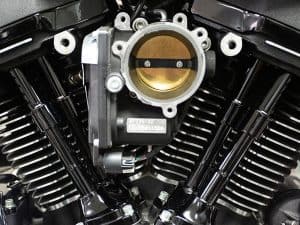 Throttle body of a high-performance motorcycle engine at Revelry Motorcycles shop in Australia.
