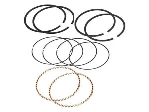 Metal piston rings for motorcycle engine repair, black and gold engine components, motorcycle engine parts for sale, Revelry Motorcycles engine repair parts, motorcycle maintenance accessories.
