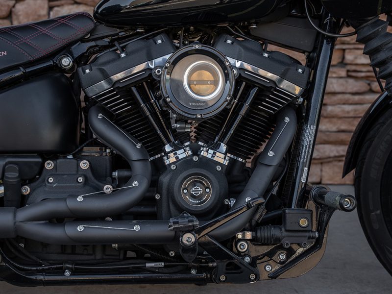 Harley-Davidson motorcycle engine with black exhaust and matte finish, showcasing custom bike build in Australia.