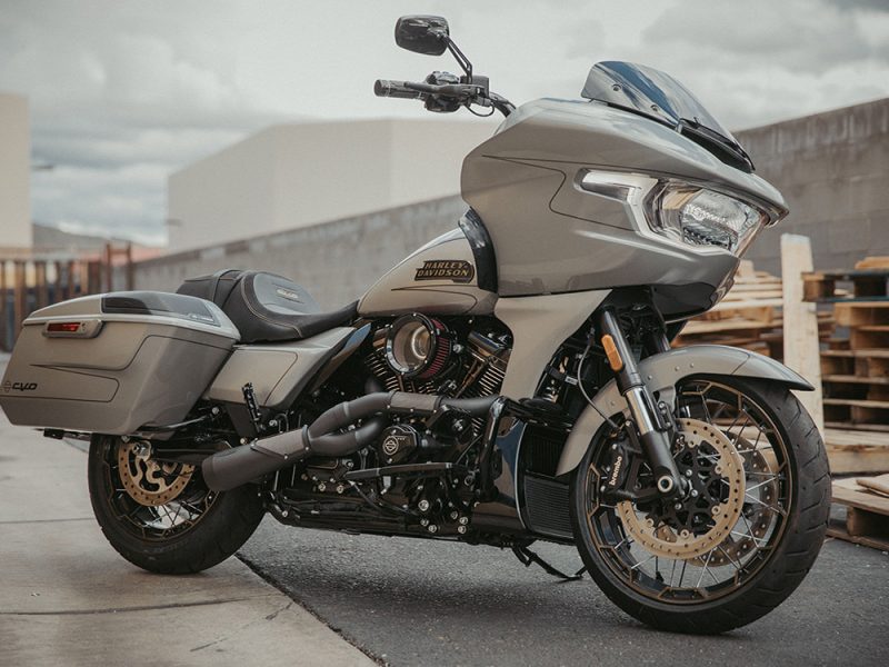 Artsy grey Harley-Davidson touring motorcycle with black accents, touring gear, and saddlebags for long-distance rides.