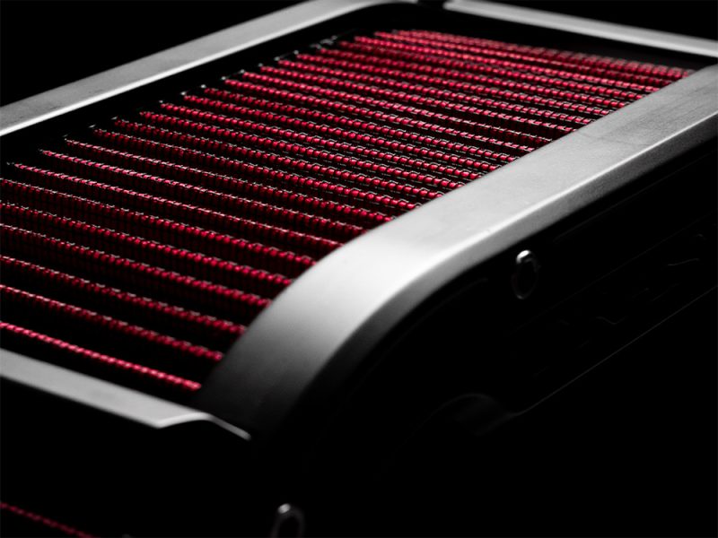 High-performance motorcycle radiator with red cooling fins and aluminium frame.