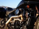 Harley-Davidson motorcycle engine with custom chrome pipes, showcasing high-performance design.