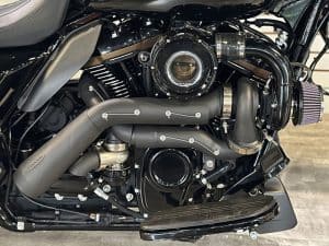 V-twin motorcycle engine featuring custom exhaust system and performance air filter.
