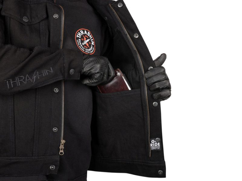 Dark motorcycle jacket with Thrasher patch and secure pocket, ideal for riding enthusiasts.