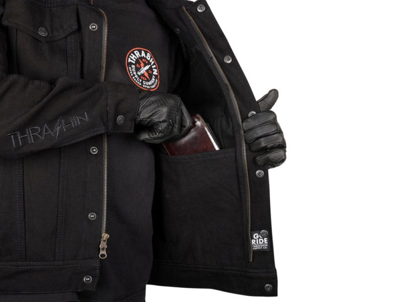 Heavy black motorcycle jacket with Thrasher patch and leather gloves, casual riding gear.