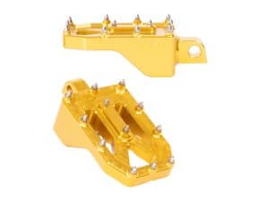 Gold motorcycle foot pegs for Revelry Motorcycles racing and touring accessories.