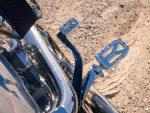 Polished motorcycle footpegs on a Revelry Motorcycles custom cruiser.