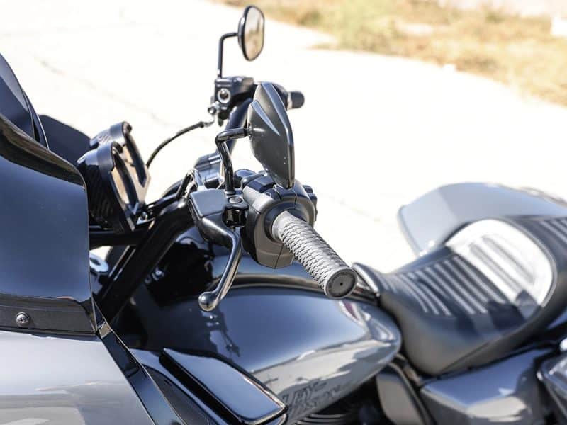 Suzuki motorcycle handlebar and control details with Revelry Cycles branding.