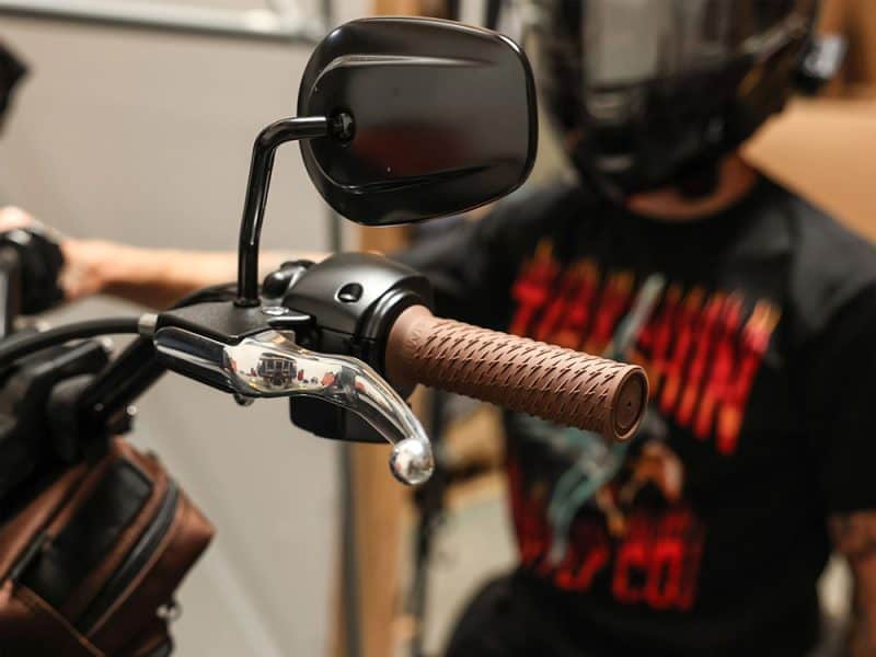 Revelry Motorcycles handlebar with brown grip and mirror, customised for rider comfort and style in Australia.