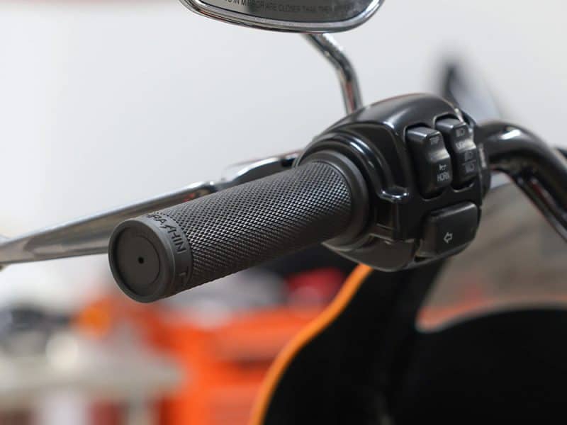 Handlebar grip and control switch on a Revelry Motorcycle, showcasing high-quality motorcycle accessories.
