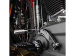 Footpegs and gear shifter on a modern motorcycle, showcasing precision engineering and sleek design.