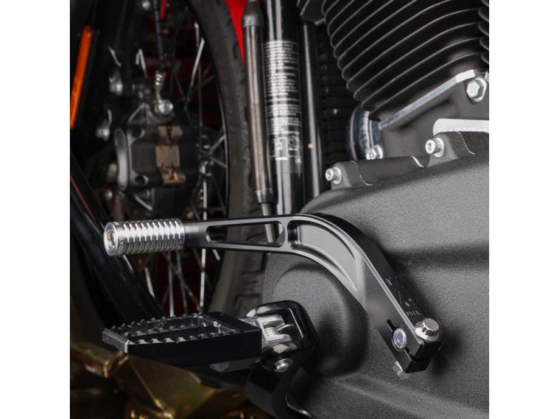 Footpegs and gear shifter on a modern motorcycle, showcasing precision engineering and sleek design.