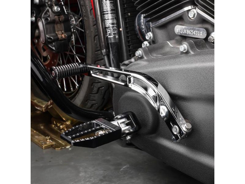 High-performance motorcycle footpeg and gear shifter on a sleek black and chrome Revelry Motorcycles bike.