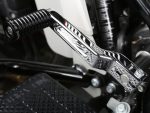 Chrome motorcycle footpeg with detailed engraving and durable metal construction.
