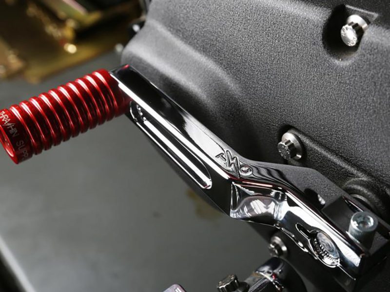 Red motorcycle shock absorber on a Revelry Motorcycles custom bike.