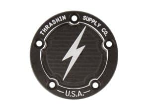 Vintage Thrasher Supply Co. motorcycle emblem, black metal with lightning bolt detail.