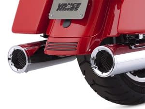 Exhaust system of a vintage red motorcycle, showcasing high-quality chrome pipes.