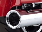 Exhaust pipe of a custom Revelry Motorcycle with polished chrome finish.