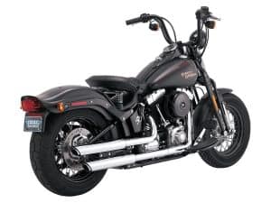 Harley Davidson cruiser motorcycle with black matte finish and chrome exhaust pipes.