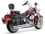 Harley Davidson motorcycle with black leather saddlebags and chrome exhaust pipes.