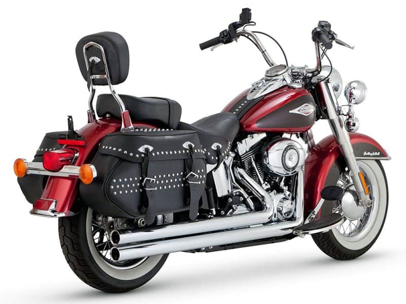 Harley Davidson motorcycle with black leather saddlebags and chrome exhaust pipes.