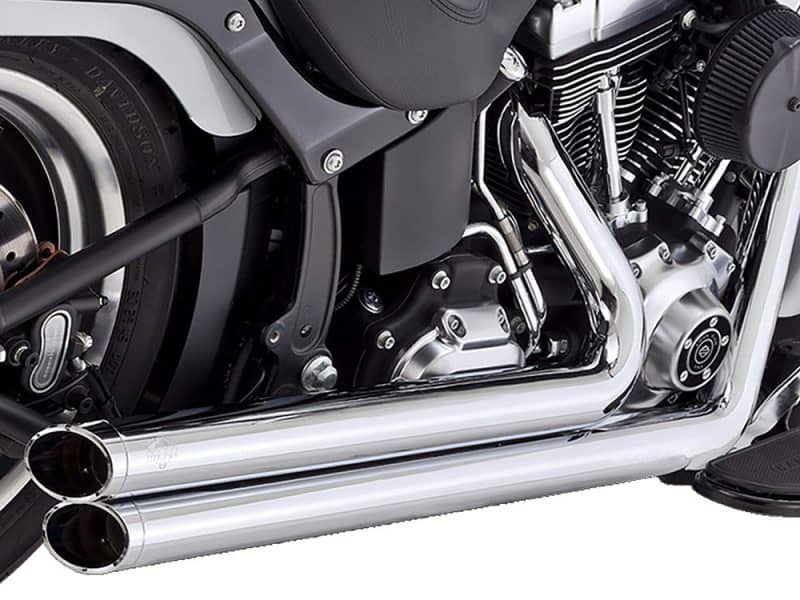Exhaust system of a custom Revelry Motorcycles cruiser in sleek chrome finish.