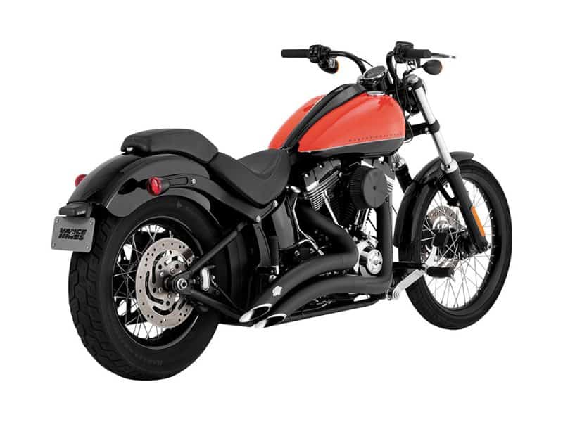 Harley Davidson motorcycle with matte black exhaust and orange fuel tank.