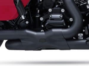 High-performance motorcycle engine close-up, showcasing sleek black exhaust and mechanical details.