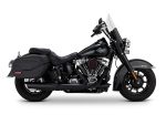 Harley Davidson touring motorcycle with black leather saddle bags and custom riding gear.