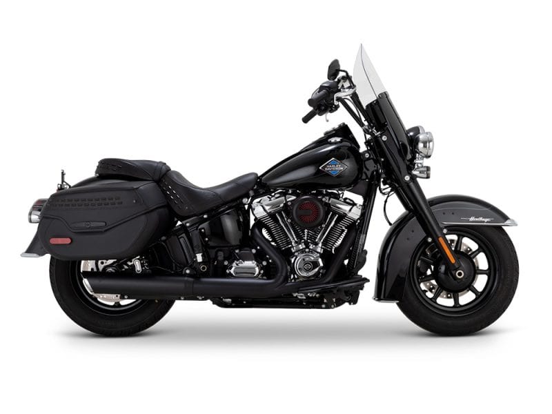 Harley Davidson touring motorcycle with black leather saddle bags and custom riding gear.