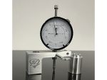 High-precision dial indicator gauge with metal mount for motorcycle precision measurements.